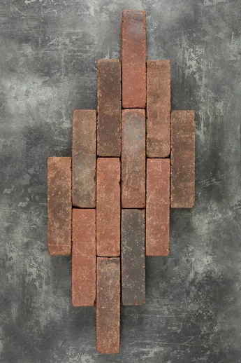 12 Antique Red Brick Pavers, part of Alpha Clay Paver Collection, arranged in lop-sided lozenge shape on grey background.