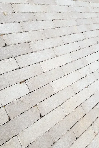 Close-up of Stone Grey Brick Paving laid running bond, showing tonal variation. Free next-day UK delivery available.