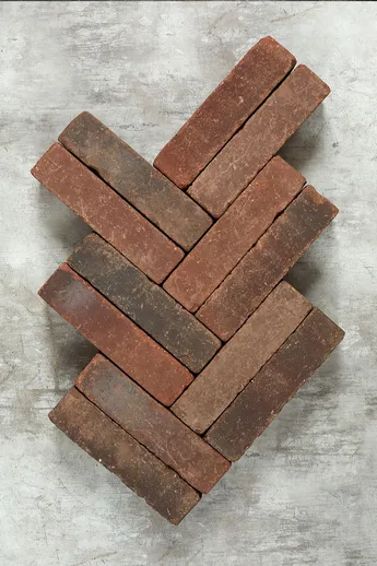 12 Antique Red Clay Pavers, showing colour variation, laid herringbone pattern on grey background. Free UK delivery available.